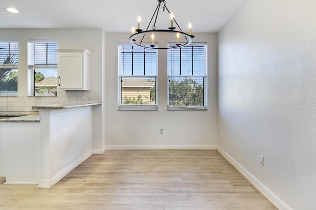 500 Pacific Grove 3 Dr Unit 3, West Palm Beach, FL 33401 - unfurnished dining area with a chandelier, light wood-style floors, baseboards, and recessed lighting