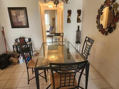 50 Berkshire B 50, West Palm Beach, FL 33417 - dining room featuring tile patterned floors and a chandelier