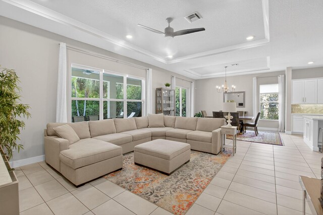 4652 Saxon Rd, Coconut Creek, FL 33073 - living room featuring a tray ceiling, a ceiling fan, light tile patterned floors, a chandelier, and recessed lighting