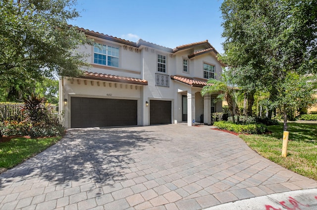 4652 Saxon Rd, Coconut Creek, FL 33073 - mediterranean / spanish home featuring a garage, a tile roof, decorative driveway, and stucco siding