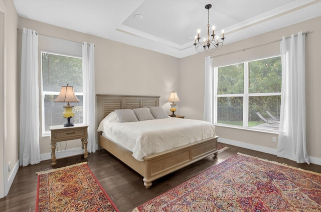 4652 Saxon Rd, Coconut Creek, FL 33073 - bedroom featuring a chandelier, dark wood finished floors, a raised ceiling, and baseboards