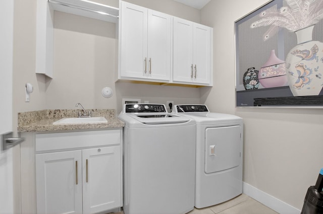 4652 Saxon Rd, Coconut Creek, FL 33073 - laundry area with washer and dryer, cabinet space, light tile patterned floors, and baseboards