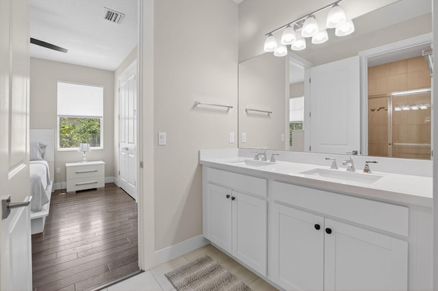 4652 Saxon Rd, Coconut Creek, FL 33073 - ensuite bathroom with double vanity, baseboards, and a tile shower