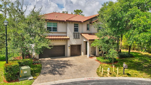 4652 Saxon Rd, Coconut Creek, FL 33073 - mediterranean / spanish-style house with a garage, a tile roof, stucco siding, and decorative driveway