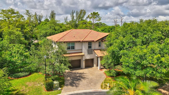 4652 Saxon Rd, Coconut Creek, FL 33073 - mediterranean / spanish-style home featuring an attached garage, a tile roof, decorative driveway, and stucco siding