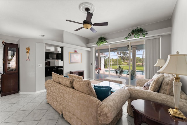 165 SE Osprey Rdg, Port Saint Lucie, FL 34984 - living room featuring a ceiling fan, light tile patterned flooring, and baseboards