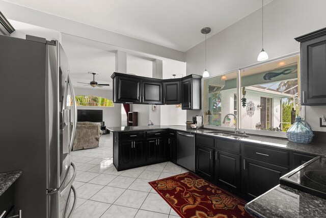 165 SE Osprey Rdg, Port Saint Lucie, FL 34984 - kitchen with appliances with stainless steel finishes, a sink, dark cabinetry, light tile patterned flooring, and ceiling fan