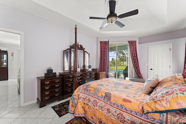 165 SE Osprey Rdg, Port Saint Lucie, FL 34984 - bedroom featuring access to exterior, a raised ceiling, a ceiling fan, baseboards, and light tile patterned floors