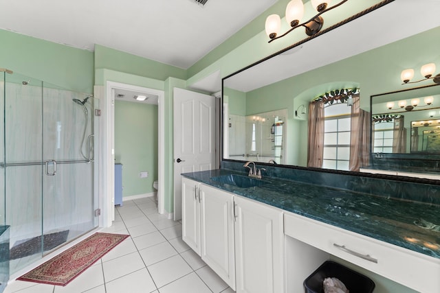 165 SE Osprey Rdg, Port Saint Lucie, FL 34984 - full bath featuring tile patterned flooring, a stall shower, toilet, vanity, and baseboards