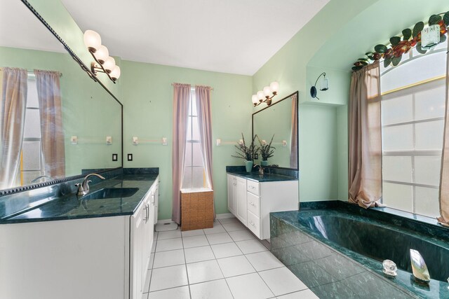 165 SE Osprey Rdg, Port Saint Lucie, FL 34984 - full bath featuring two vanities, a garden tub, and tile patterned flooring