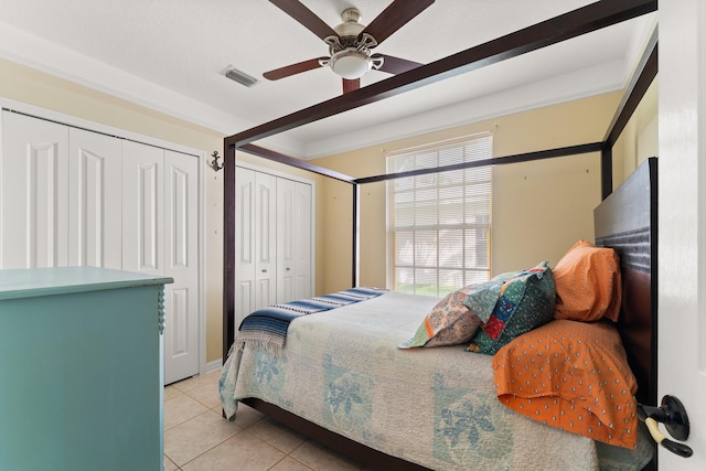 165 SE Osprey Rdg, Port Saint Lucie, FL 34984 - bedroom with light tile patterned flooring, ceiling fan, and multiple closets