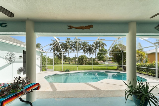 165 SE Osprey Rdg, Port Saint Lucie, FL 34984 - outdoor pool with a patio, ceiling fan, and glass enclosure