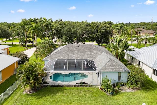 165 SE Osprey Rdg, Port Saint Lucie, FL 34984 - outdoor pool featuring a patio, glass enclosure, and view of wooded area