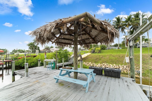 165 SE Osprey Rdg, Port Saint Lucie, FL 34984 - wooden deck with a boat dock, a yard, and a water view