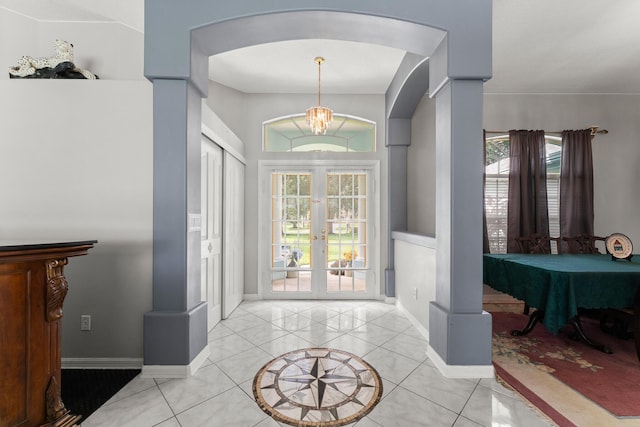 165 SE Osprey Rdg, Port Saint Lucie, FL 34984 - foyer featuring arched walkways, french doors, light tile patterned flooring, and baseboards