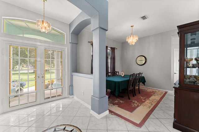 165 SE Osprey Rdg, Port Saint Lucie, FL 34984 - dining area featuring a chandelier, french doors, arched walkways, and baseboards