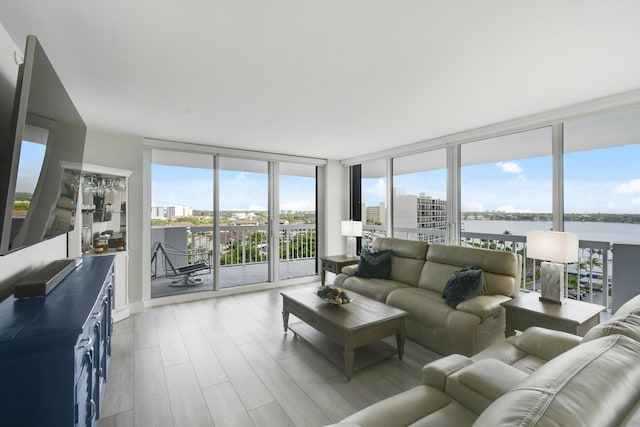 123 Lakeshore Dr Unit 1145, North Palm Beach, FL 33408 - living room featuring floor to ceiling windows, a water view, and light wood-type flooring