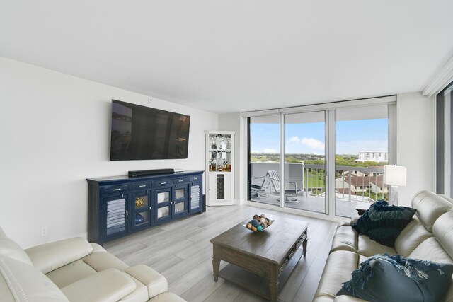 123 Lakeshore Dr Unit 1145, North Palm Beach, FL 33408 - living room featuring expansive windows and light wood finished floors