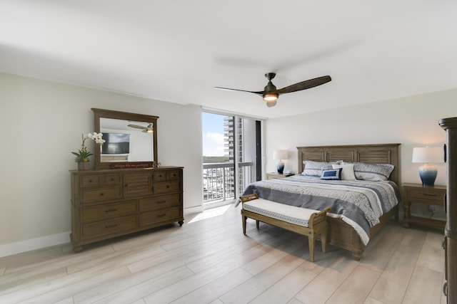 123 Lakeshore Dr Unit 1145, North Palm Beach, FL 33408 - bedroom featuring floor to ceiling windows, access to exterior, light wood-style flooring, ceiling fan, and baseboards