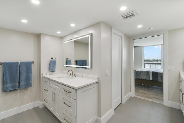 123 Lakeshore Dr Unit 1145, North Palm Beach, FL 33408 - ensuite bathroom featuring vanity, baseboards, and recessed lighting