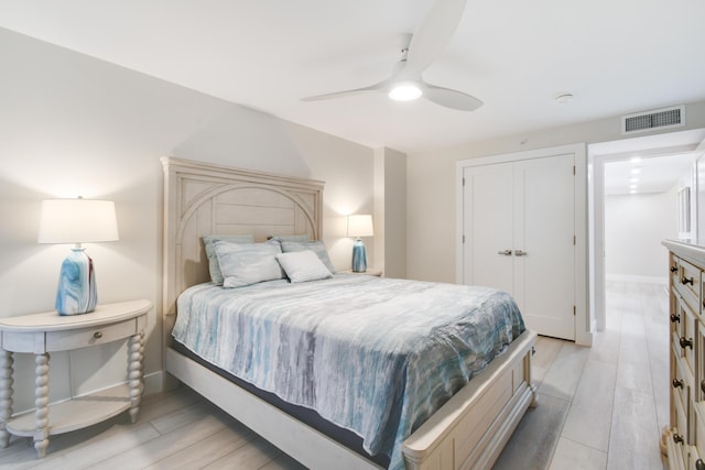 123 Lakeshore Dr Unit 1145, North Palm Beach, FL 33408 - bedroom featuring light wood-style flooring, a ceiling fan, a closet, and baseboards