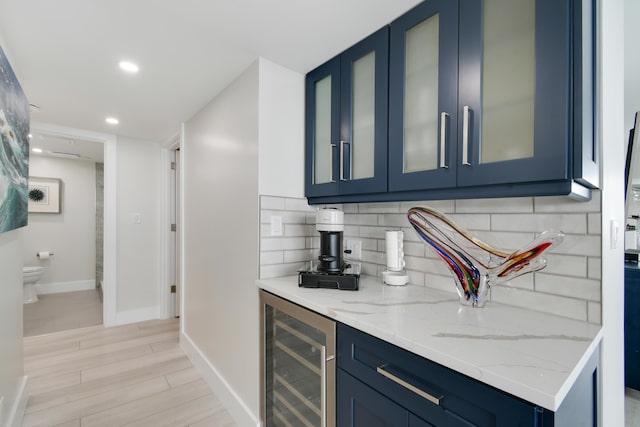 123 Lakeshore Dr Unit 1145, North Palm Beach, FL 33408 - indoor wet bar featuring beverage cooler, baseboards, decorative backsplash, light wood-type flooring, and recessed lighting