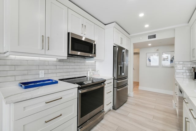 123 Lakeshore Dr Unit 1145, North Palm Beach, FL 33408 - kitchen featuring appliances with stainless steel finishes, tasteful backsplash, white cabinetry, baseboards, and recessed lighting