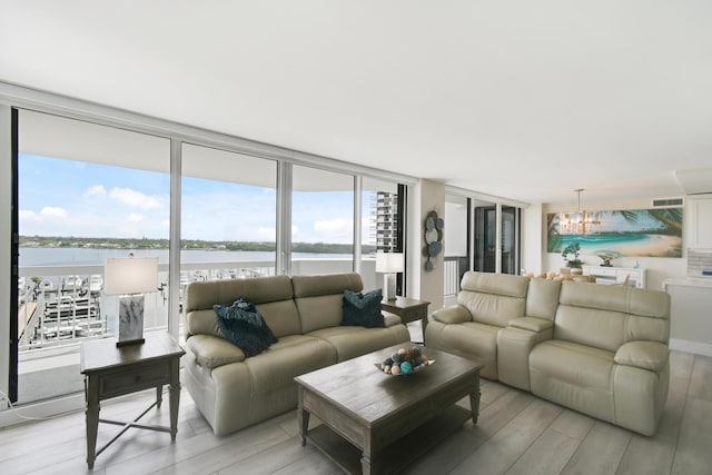 123 Lakeshore Dr Unit 1145, North Palm Beach, FL 33408 - living area with light wood-type flooring, a chandelier, plenty of natural light, and a water view