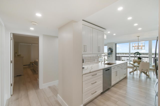 123 Lakeshore Dr Unit 1145, North Palm Beach, FL 33408 - kitchen featuring dishwasher, a sink, light wood-style floors, recessed lighting, and white cabinets