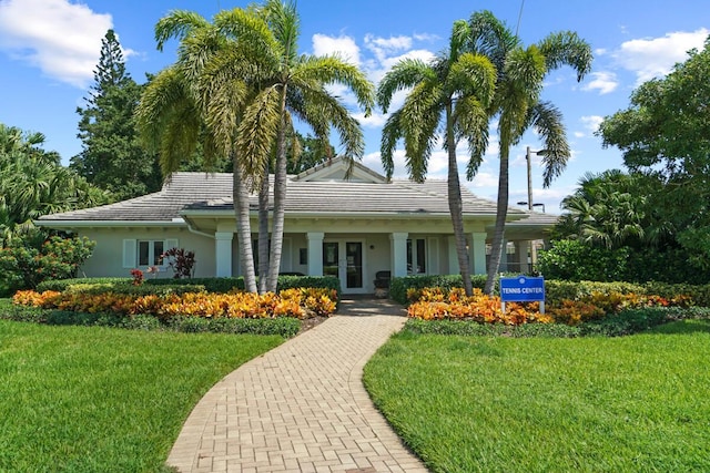 123 Lakeshore Dr Unit 1145, North Palm Beach, FL 33408 - ranch-style house with a front lawn, stucco siding, french doors, and a tiled roof