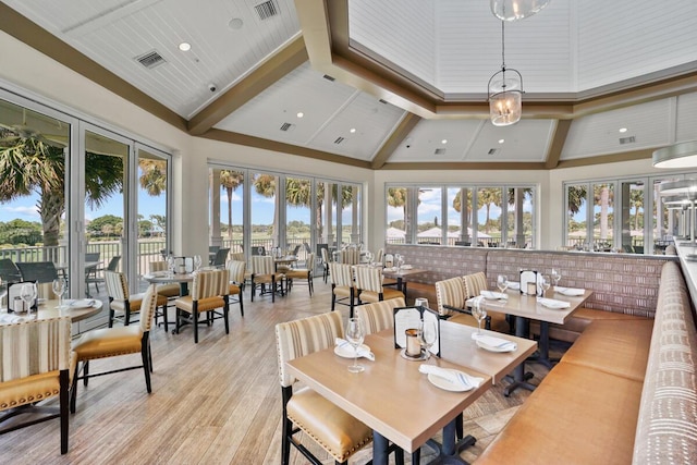 123 Lakeshore Dr Unit 1145, North Palm Beach, FL 33408 - dining room with high vaulted ceiling, plenty of natural light, light wood-style floors, and beamed ceiling
