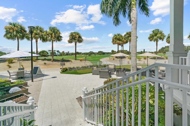 123 Lakeshore Dr Unit 1145, North Palm Beach, FL 33408 - surrounding community with an outdoor living space, a patio area, view of golf course, and a fenced backyard