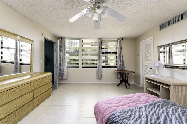 2800 N Ocean Dr Unit A-2B, Singer Island, FL 33404 - bedroom with a textured ceiling, light tile patterned floors, multiple windows, and ceiling fan