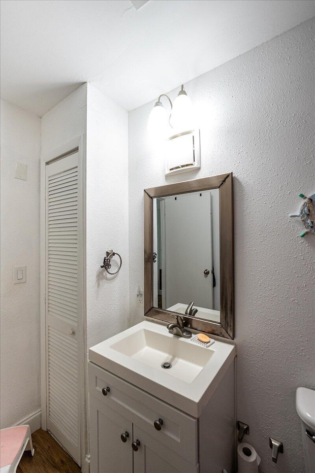 300 SW Prima Vista Blvd, Port Saint Lucie, FL 34983 - bathroom with vanity, toilet, and wood finished floors