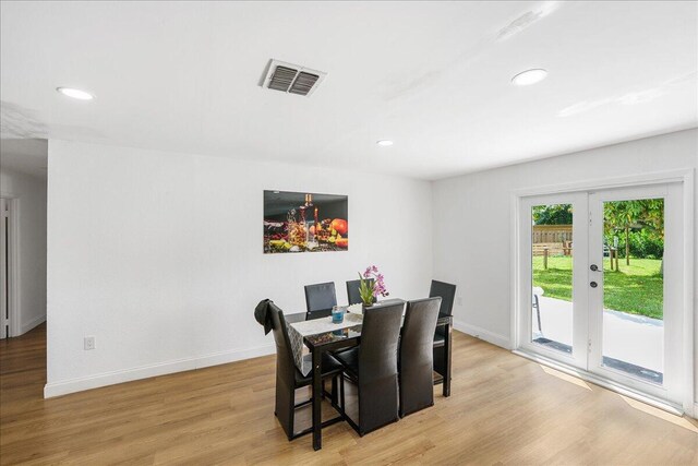300 SW Prima Vista Blvd, Port Saint Lucie, FL 34983 - dining area with light wood-type flooring, baseboards, recessed lighting, and french doors