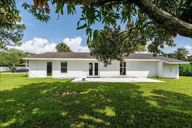 300 SW Prima Vista Blvd, Port Saint Lucie, FL 34983 - back of house with french doors, a lawn, and a patio