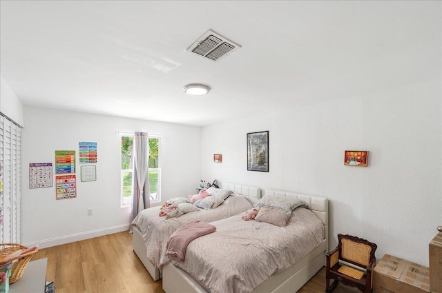 300 SW Prima Vista Blvd, Port Saint Lucie, FL 34983 - bedroom featuring light wood finished floors and baseboards
