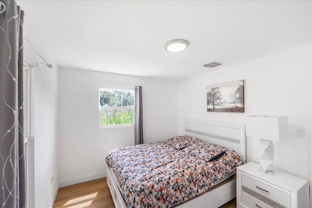 300 SW Prima Vista Blvd, Port Saint Lucie, FL 34983 - bedroom with wood finished floors and baseboards