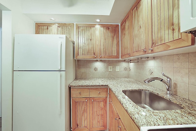 2501 N Ocean Blvd Unit 3, Pompano Beach, FL 33062 - kitchen with freestanding refrigerator, tasteful backsplash, and light stone counters