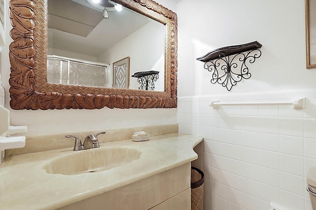 2501 N Ocean Blvd Unit 3, Pompano Beach, FL 33062 - bathroom featuring vanity, tile walls, wainscoting, and a shower