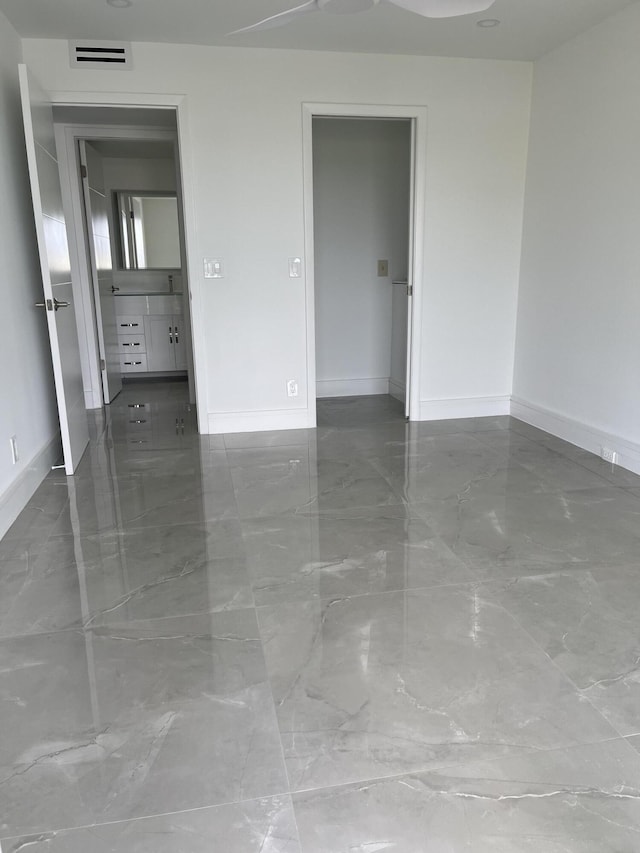 3033 Wolverton B, Boca Raton, FL 33434 - empty room featuring baseboards and marble finish flooring