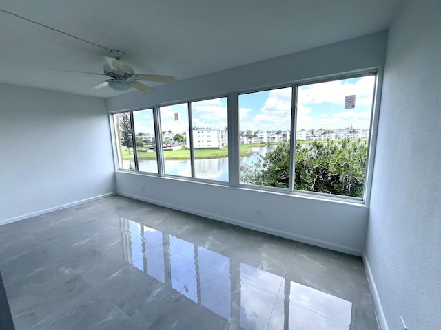 3033 Wolverton B, Boca Raton, FL 33434 - spare room featuring baseboards and ceiling fan