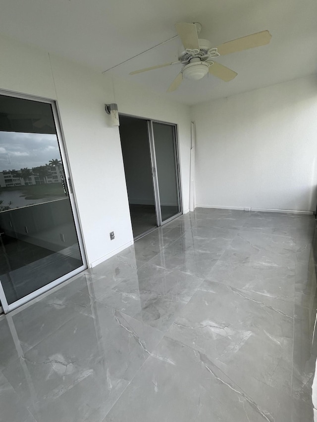 3033 Wolverton B, Boca Raton, FL 33434 - empty room featuring a ceiling fan and marble finish floors