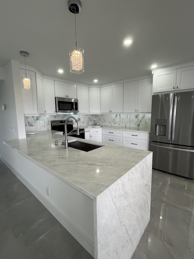 3033 Wolverton B, Boca Raton, FL 33434 - kitchen featuring appliances with stainless steel finishes, tasteful backsplash, white cabinets, a peninsula, and light stone counters