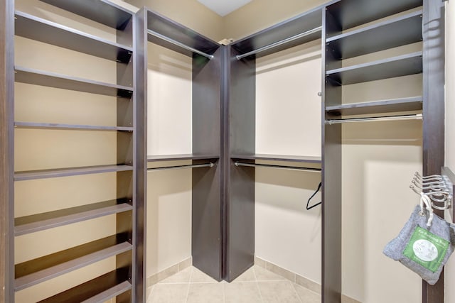 11013 Legacy Ln Unit 103, Palm Beach Gardens, FL 33410 - walk in closet with light tile patterned floors