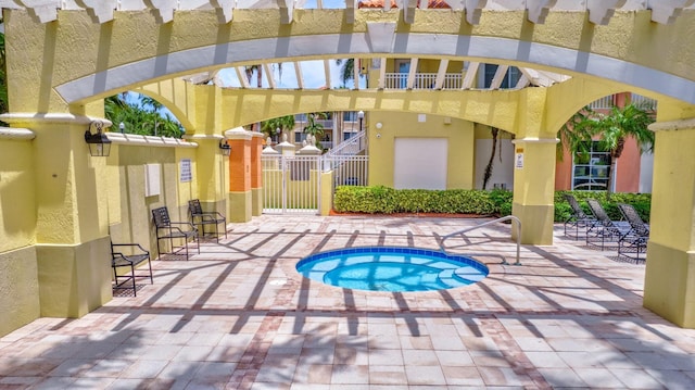 11013 Legacy Ln Unit 103, Palm Beach Gardens, FL 33410 - view of swimming pool with a gate, a pergola, a community hot tub, and a patio