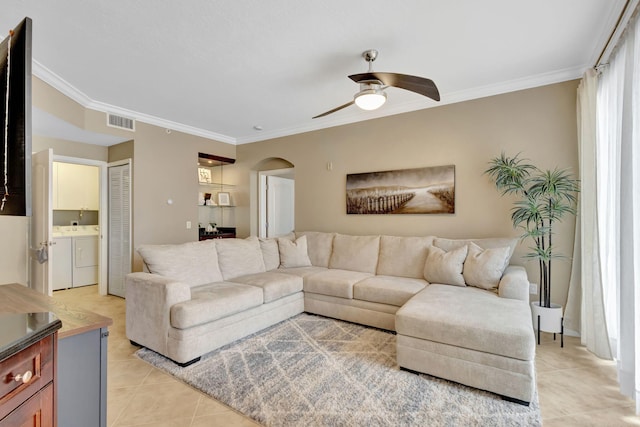 11013 Legacy Ln Unit 103, Palm Beach Gardens, FL 33410 - living room with separate washer and dryer, light tile patterned floors, ceiling fan, arched walkways, and ornamental molding
