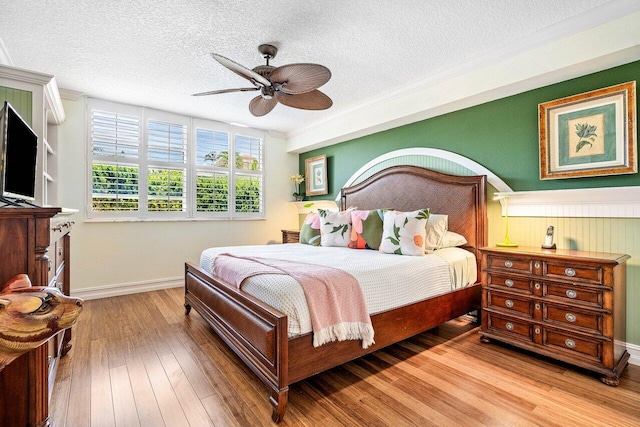 3606 S Ocean Blvd Unit 201, Highland Beach, FL 33487 - bedroom with a textured ceiling, wood finished floors, ornamental molding, baseboards, and ceiling fan