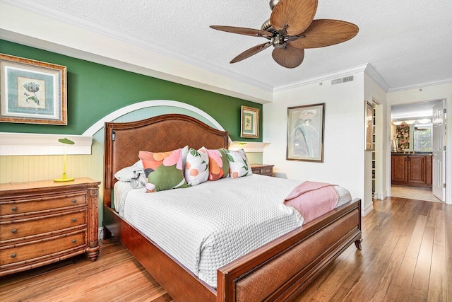 3606 S Ocean Blvd Unit 201, Highland Beach, FL 33487 - bedroom with hardwood / wood-style floors, crown molding, a textured ceiling, and ceiling fan