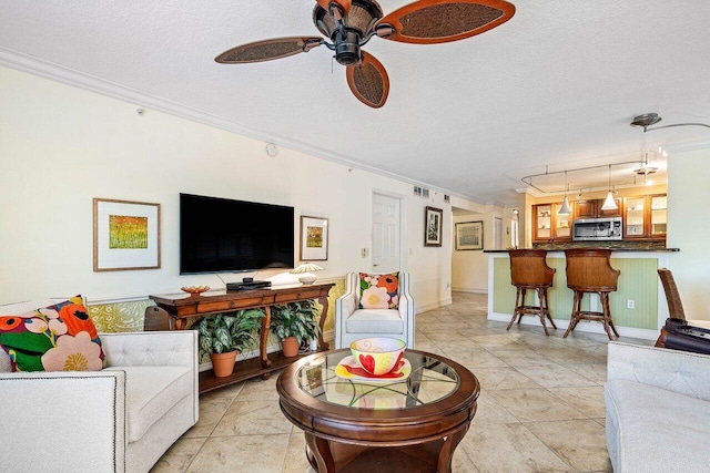 3606 S Ocean Blvd Unit 201, Highland Beach, FL 33487 - living area with crown molding, a ceiling fan, a textured ceiling, light tile patterned floors, and track lighting